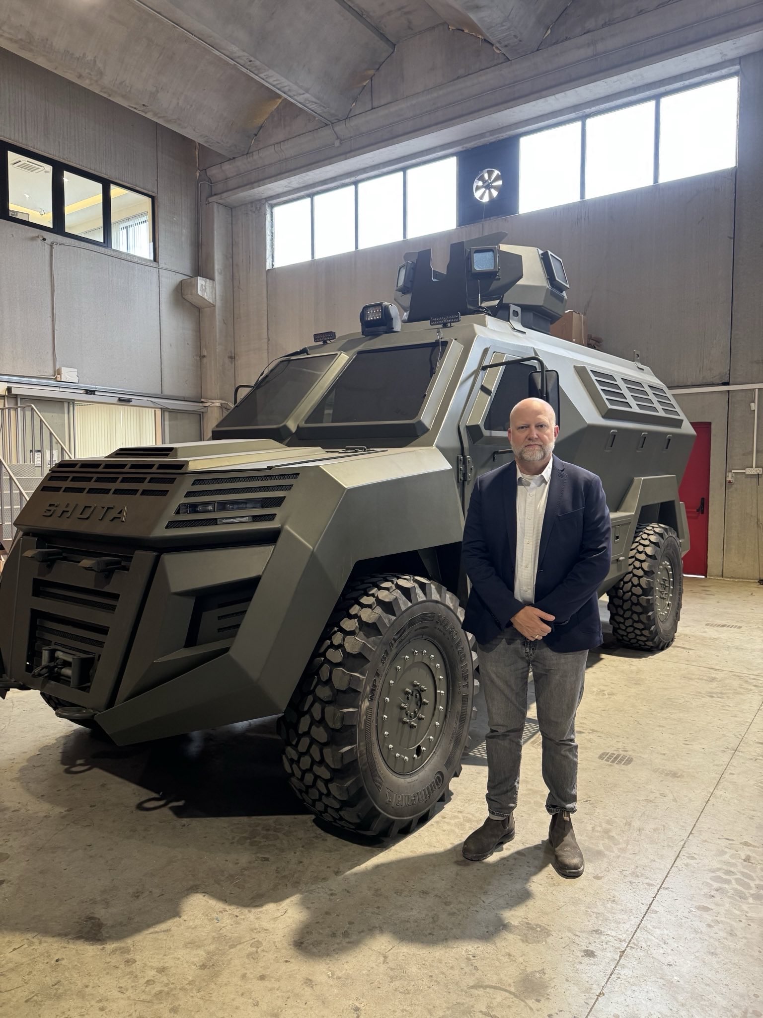 Victor Myers visiting a security vehicle facility